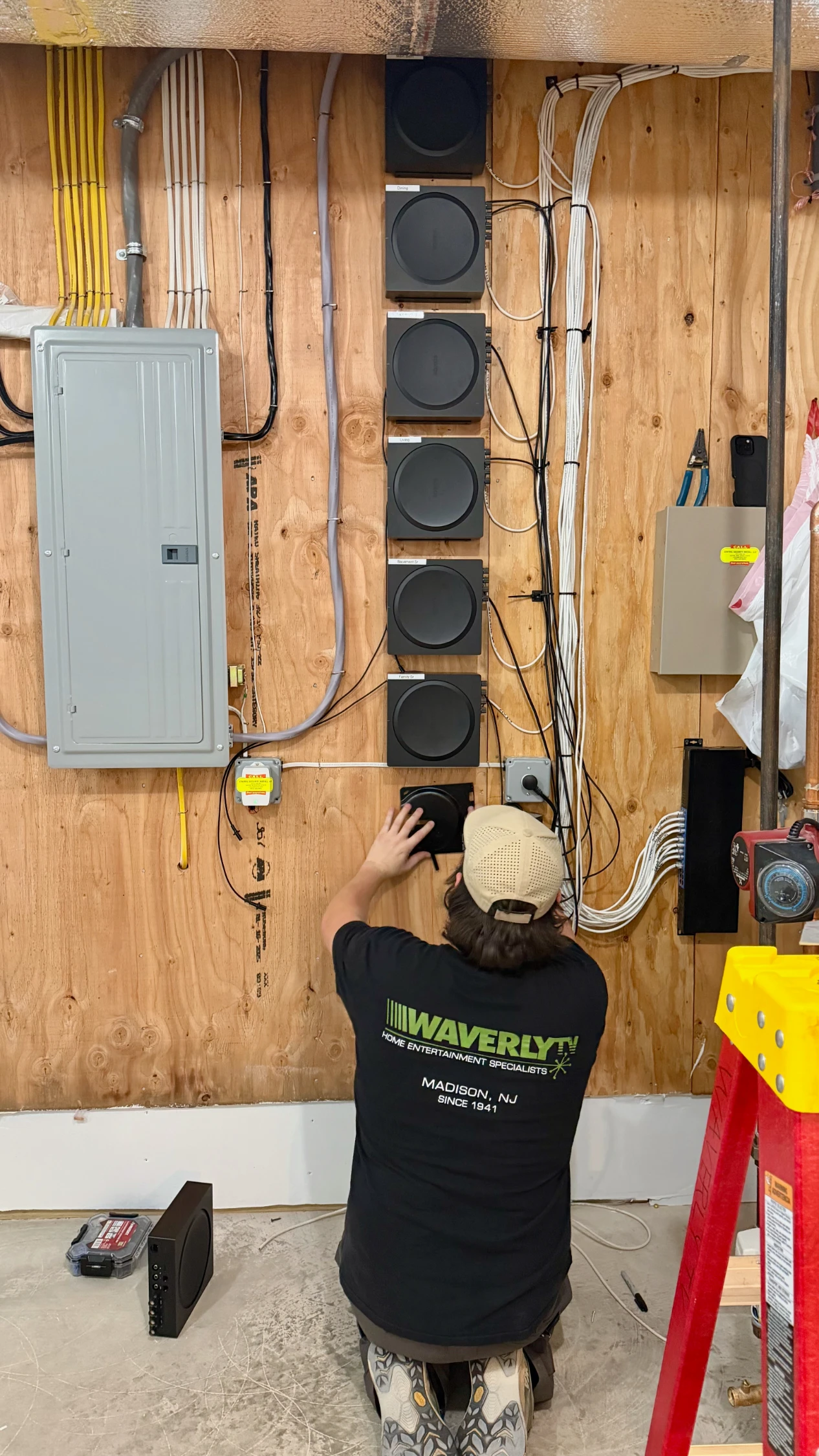 Waverly TV technician wiring a Sonos Amp headend