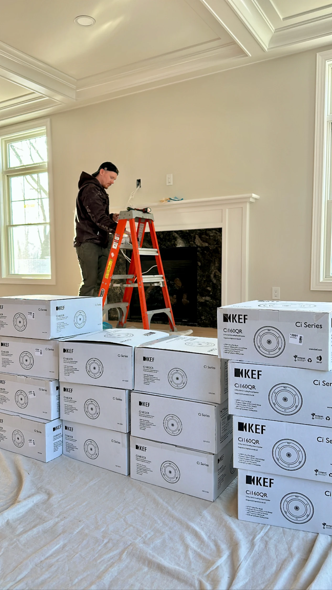 KEF in-ceiling speaker installation with ladder and speaker boxes