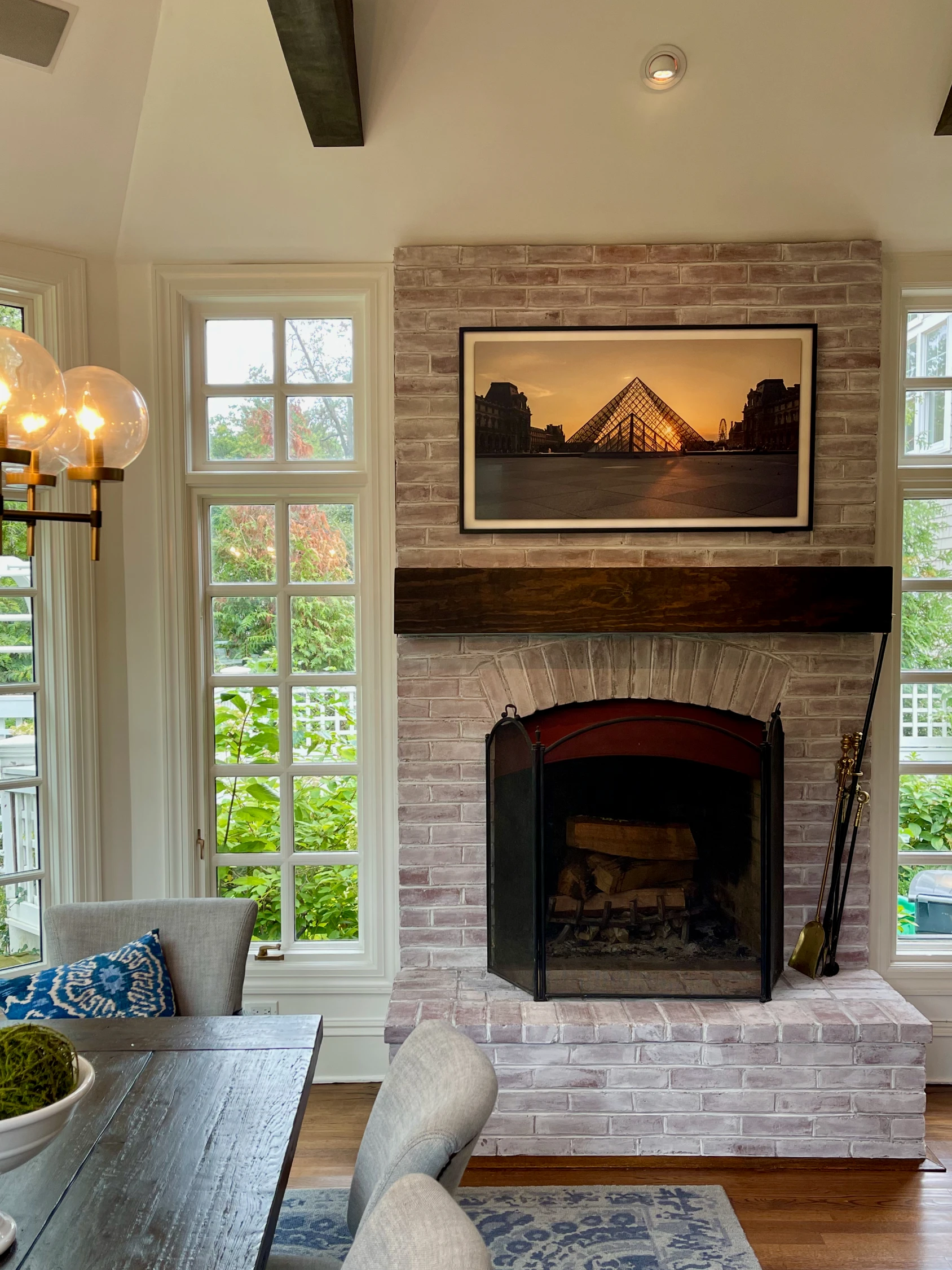 Frame TV mounted above a stone fireplace
