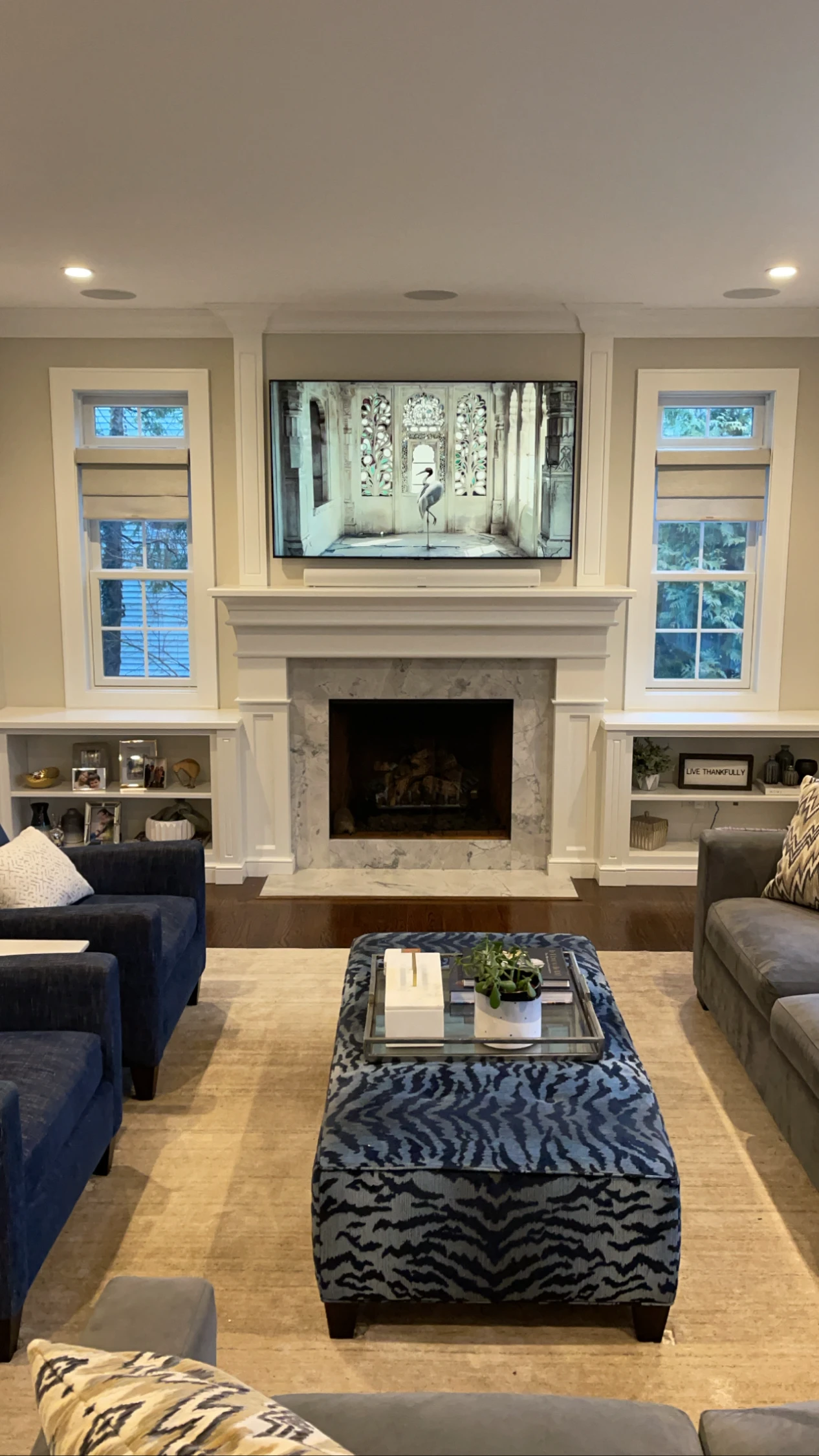TV above a white fireplace surround