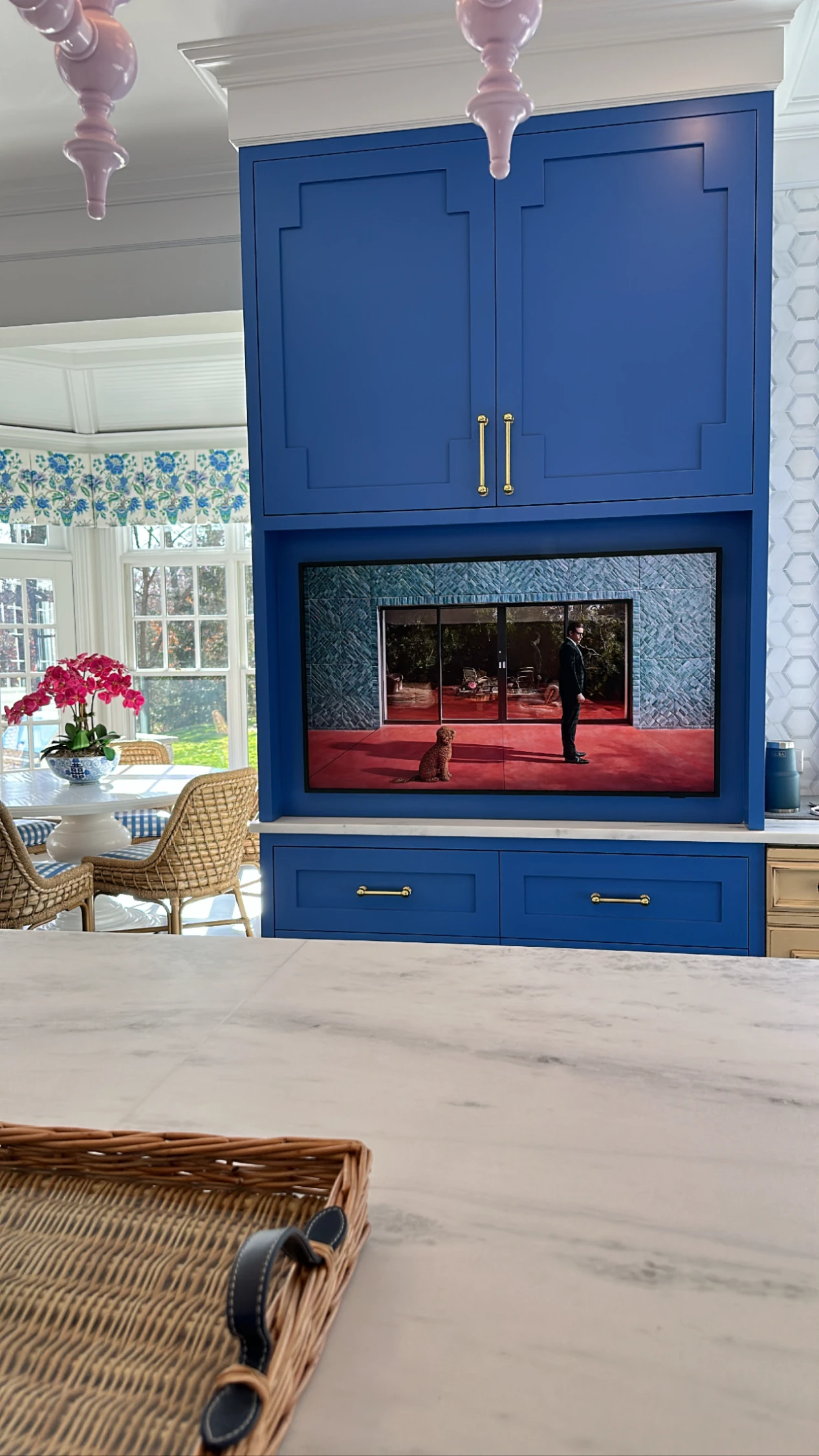 TV integrated into a kitchen with blue cabinetry