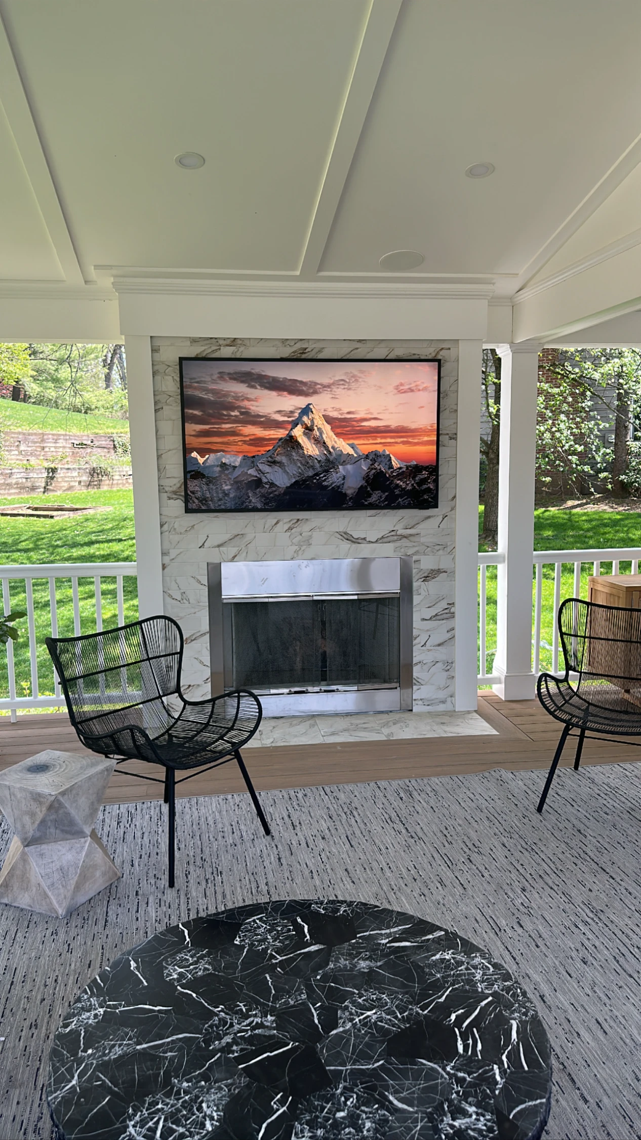 Covered outdoor living space with TV installation