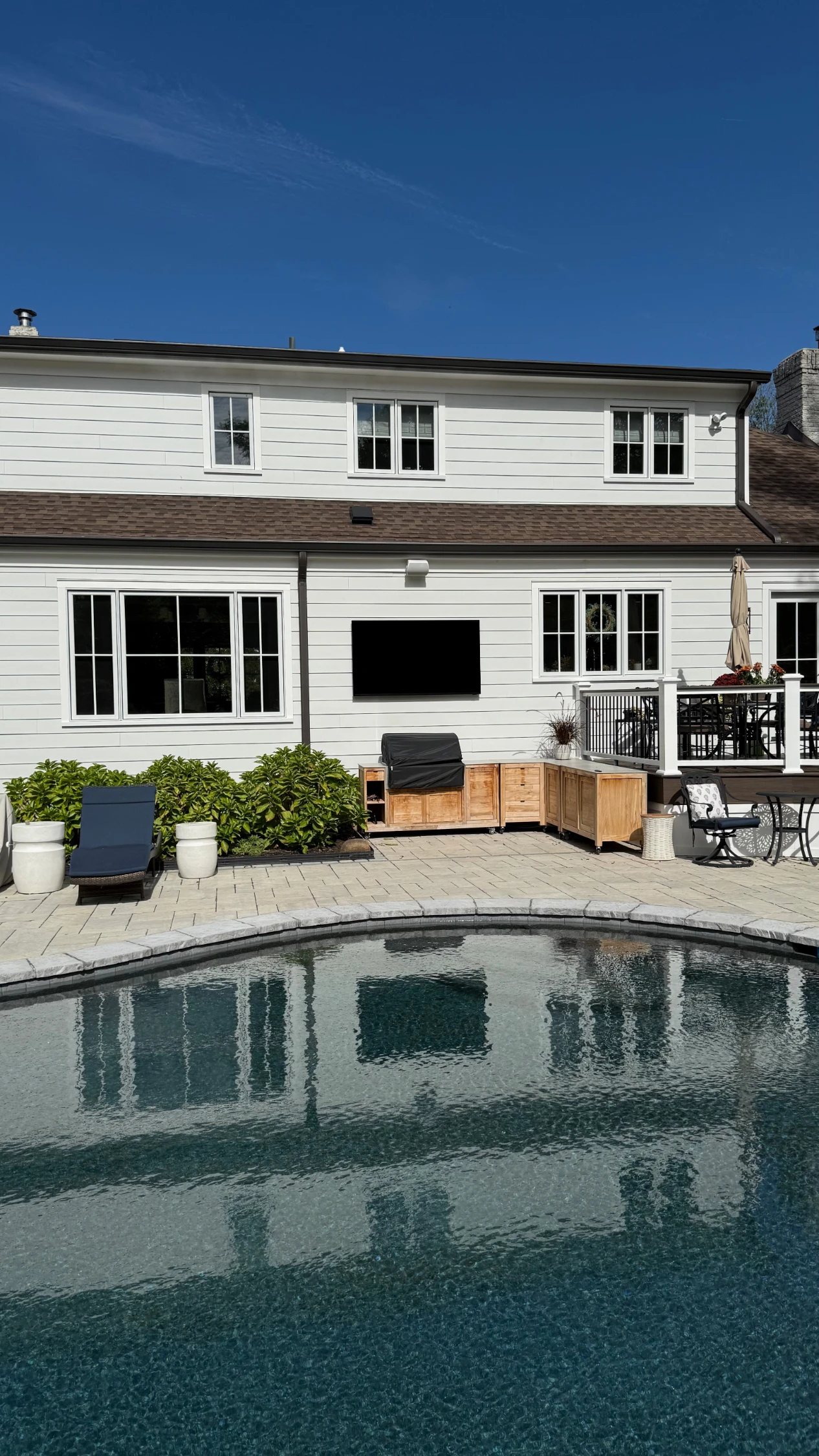 TV wall-mounted in an outdoor pool area