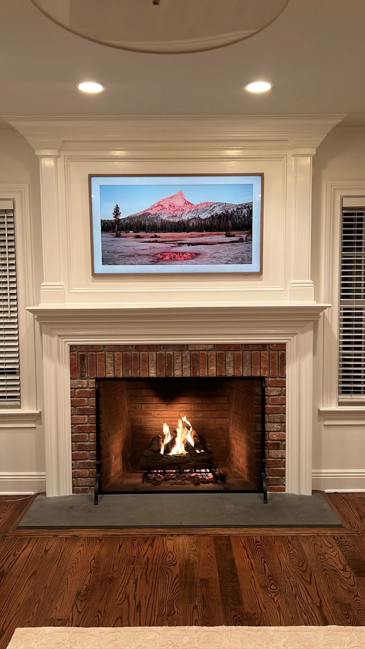 Samsung Frame TV above a wood-burning fireplace