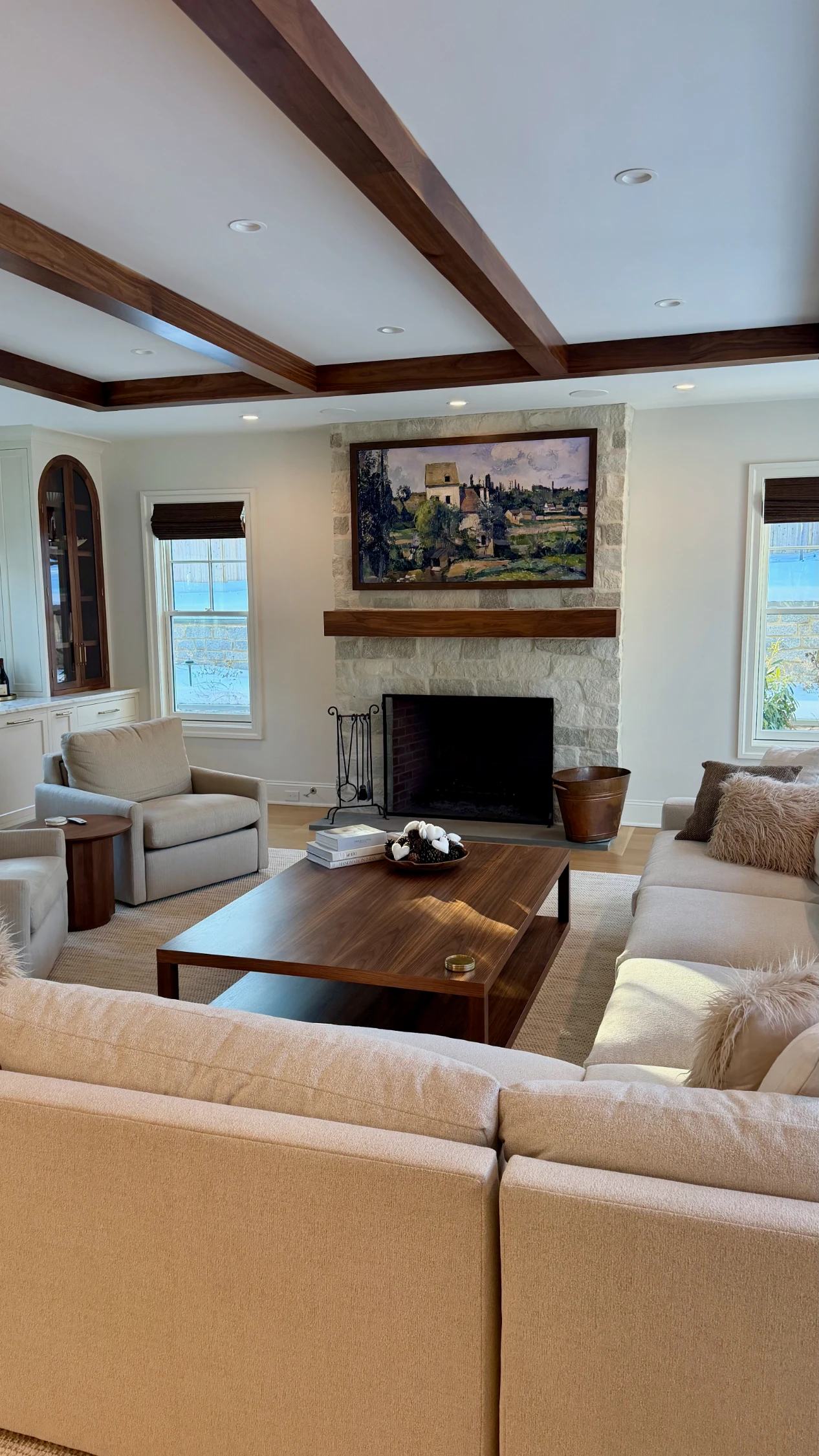 TV above a fireplace with wood texture wall